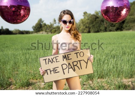 beautiful sexy party woman in a field with a sign saying take me to the party