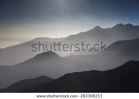 misty view of hills and valleys in the atlas mountains, morocco