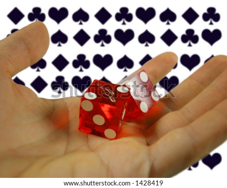 hand holding casino dice with playing card symbols in background