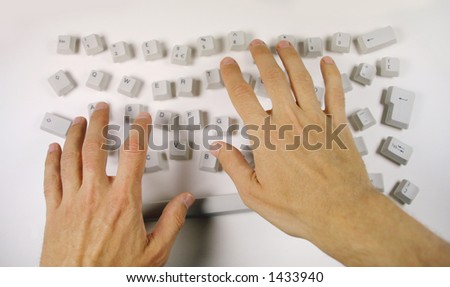 keys from a computer keyboard arranged in a messy pattern with typing hands