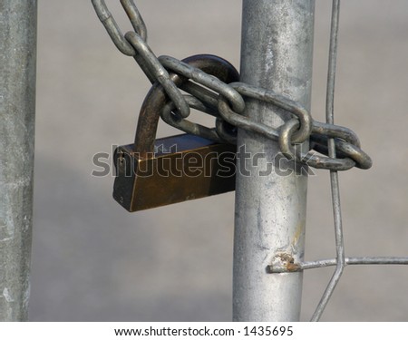 close up of a large lock and chain securing an urban building