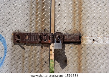 small padlock and metal gate