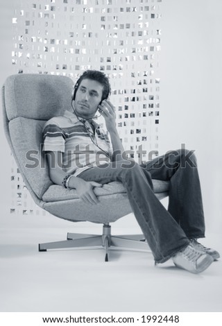 a man relaxes in a chair listening to music
