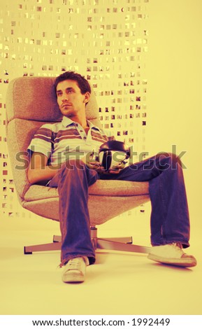 a man relaxes in a chair listening to music