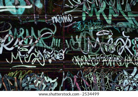 graffiti tags on wooden door in rome, italy