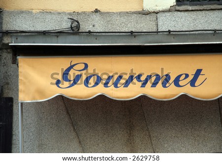 gourmet written on a shops umbrella madrid spain