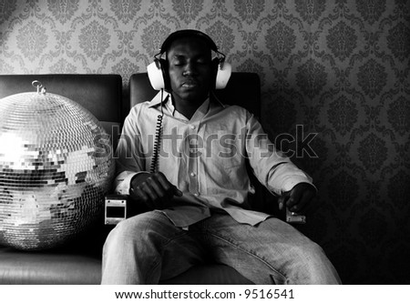 young cool man listens to music with headphones
