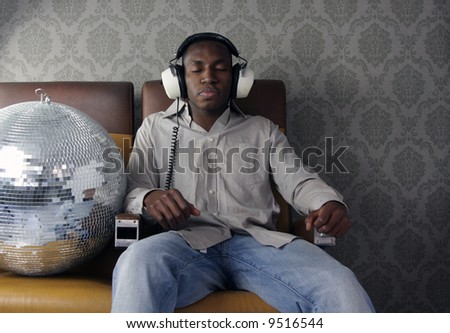young cool man listens to music with headphones