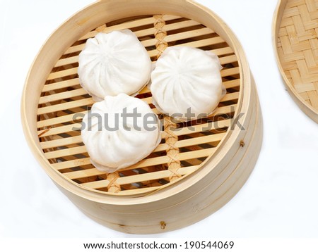 steamed bun in  traditional oriental dim sum bamboo steam cooker