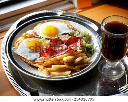 eggs sunny side up meat fries and coffee breakfast by the early morning  window light