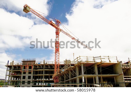industrial crane multi level building in construction  sky and clouds.