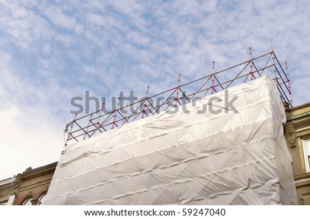 old architecture in renovation with clouds and blue sky .