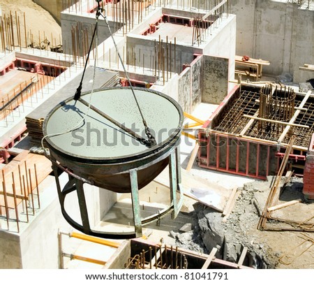 construction industrial concrete mixing container loading cement by crane hoist over work-site of new building project. view from the top, bird\'s eye panoramic view.