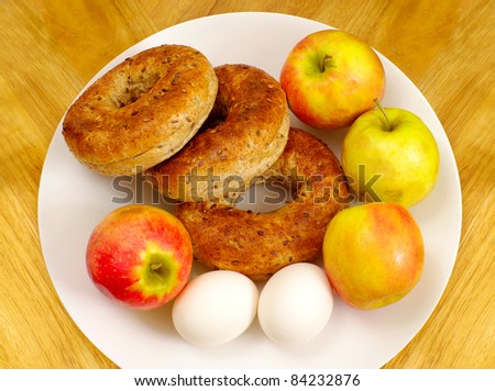 healthy wholesome nutritious breakfast apple bagel egg white plate  food table serving.