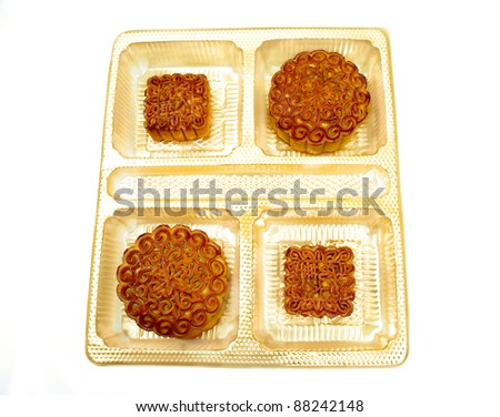 oriental pastry chinese moon cake  with mandarin characters design . top view . expensive  festival bakery gifts . white background
