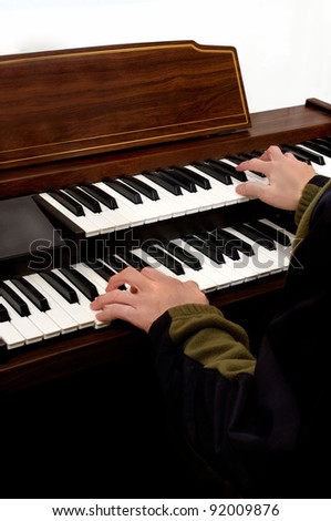 hands playing musical keyboard instrument of electronic organ .