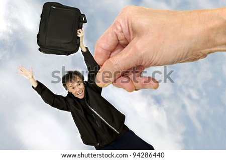 business planning and  success concept. a hand in the sky picking up a man with suitcase  .