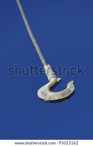 Metal hook of the elevating crane hanging down from the sky