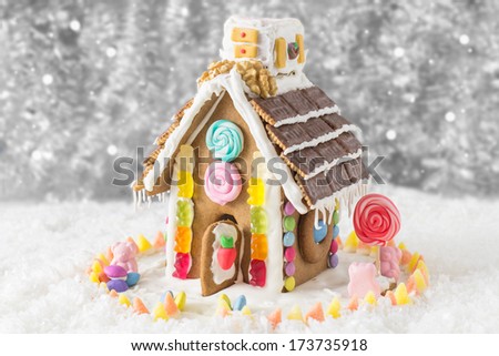 A candy coated gingerbread house in a Christmas display