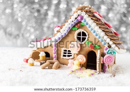 A candy coated gingerbread house in a Christmas display