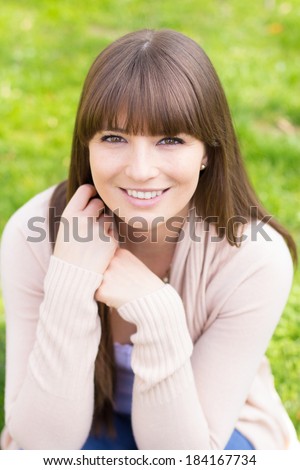 Carefree young woman in pink cardigan sweater