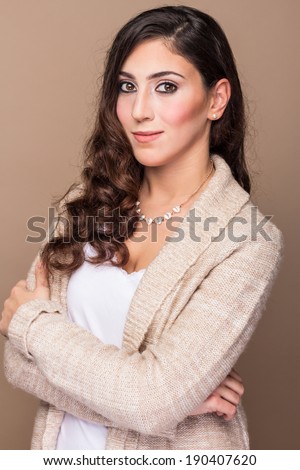 Casual woman in cardigan sweater arms crossed