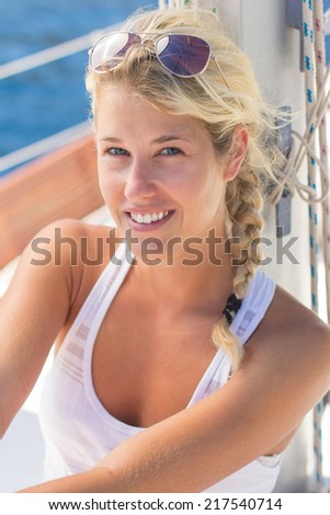 young woman sitting in the sun on a boat