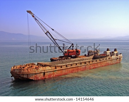 Old barge used to transport heavy goods and sand near Corfu (Greece)