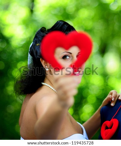close-up portrait of a pretty shy bride with heart in hand