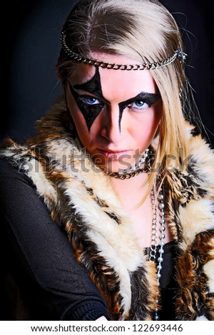 Fashion  portrait of young woman with creative make-up dressed a fur coat