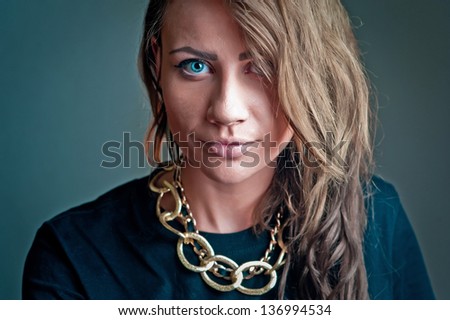 Close-up face Fashion women brunet beauty portrait  with a massive gold chain on her neck