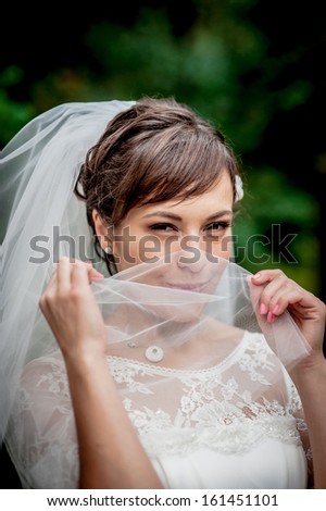 close-up portrait of a pretty shy bride on the outdoor