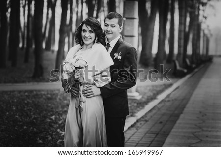 retro wedding couple in park. kiss and hug each other