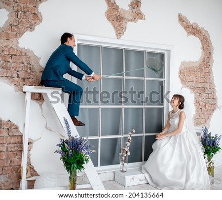 wedding couple in the interior of a white studio