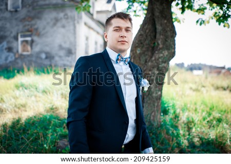 Handsome young groom head and shoulders portrait