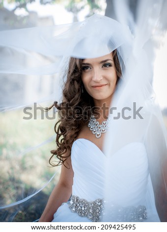 happy bride in a beautiful natural landscape in wedding dress