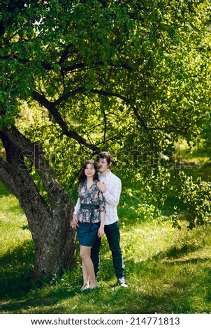 portrait of young happy beautiful couple on nature. love story. They kiss and hug each other.