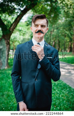 funny groom with false mustache