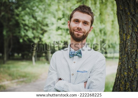 Happy young groom with a beard on their wedding day.