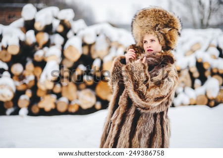 Winter beautiful Girl in Luxury Fur Coat and hat. Fashion Fur.