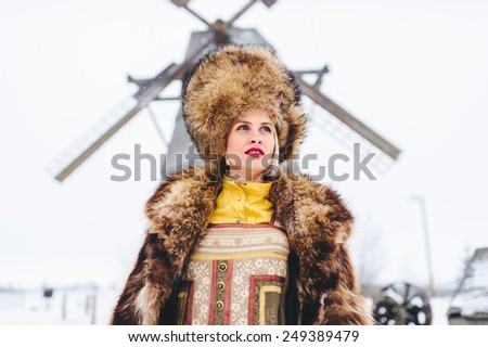 Winter beautiful Girl in Luxury Fur Coat and hat