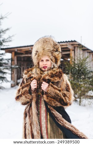 Winter beautiful Girl in Luxury Fur Coat and hat
