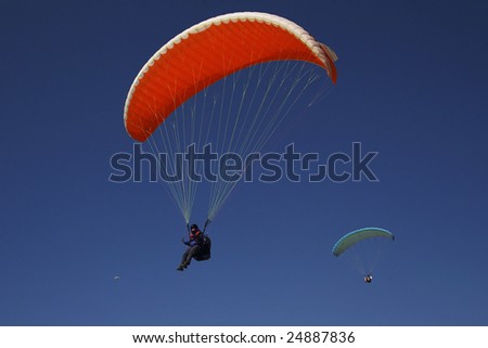 red paraglider on blue sky at sport festival in babadag oludeniz turkey