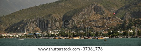 Fethiye (Ancient Telmessos) Panorama, old town and harbor from sea, Lycian rock tombs and old castle on the hills.