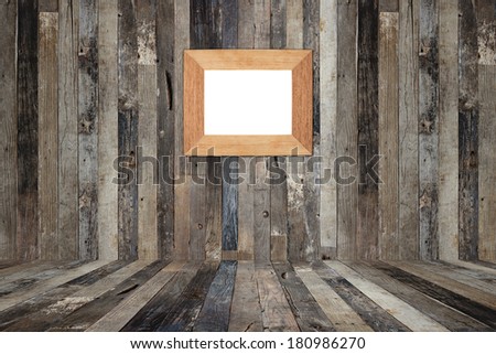 Wooden picture frame on the old wooden wall