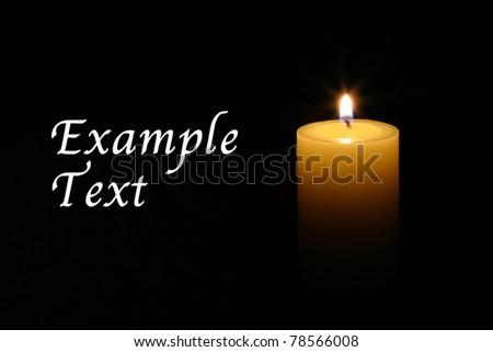 A single burning candle isolated with black background