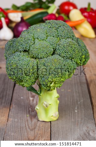 single sprouting broccoli relating to the old table with vegetables