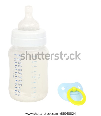 Soother and feeding bottle, isolated on background