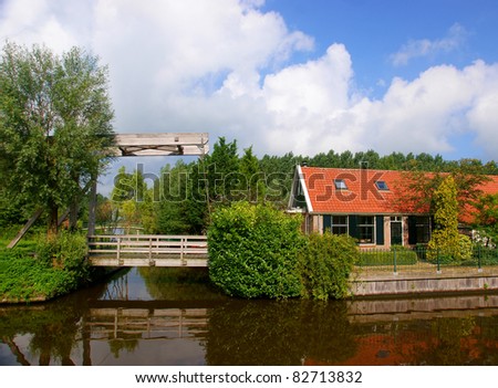 Dutch house near the river, with a bridge