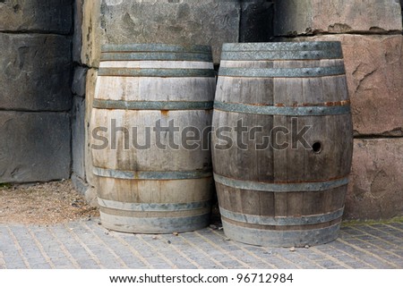 Old wooden barrels against a wall